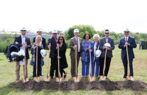 From left, William Jones, vice president of operations; Jennifer Turney, merchandise manager; Mark Sanders, senior vice president buyer; CEO Bill Jones (holding grandson Murphy Jones); Sharri Jones, executive secretary; Michael Bohner, vice president; CFO Kim Rieve; Founder Sissy Jones; Wyatt Jones, sales professional; and President Lamar McCubbin.