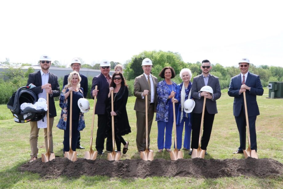 From left, William Jones, vice president of operations; Jennifer Turney, merchandise manager; Mark Sanders, senior vice president buyer; CEO Bill Jones (holding grandson Murphy Jones); Sharri Jones, executive secretary; Michael Bohner, vice president; CFO Kim Rieve; Founder Sissy Jones; Wyatt Jones, sales professional; and President Lamar McCubbin.