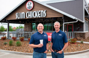 Tom Gordon, left, and Greg Smart shared a vision in founding restaurant chain  Slim Chickens of Fayetteville: “The vision was always to have a big company,” said Gordon.  The pair are shown at a new location in Springdale.