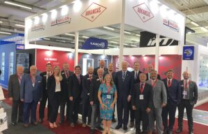 Arkansas' delegation to the 2019 Paris Air Show poses for a photo at the Arkansas booth. The group includes Gov. Asa Hutchinson and Mike Preston, executive director of the Arkansas Economic Development Commission.