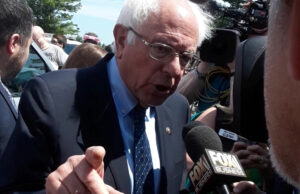 U.S. Sen. Bernie Sanders (I-Vermont) speaks to reporters in Rogers after presenting a proposal at Wednesday's Walmart Inc. business meeting.