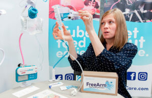 Misti Staley demonstrates her new medical device, the FreeArm, which can hold a bolus syringe, up to 500 ml of volume and a small pump.