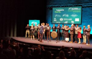 Spencer Jones, FIS enterprise product officer, flanked by the 2019 VC Fintech Accelerator participants, walks over to the Venture Center's ceremonial gong. He rang it Wednesday night to signal the end of the program, at the conclusion of its demo day event.