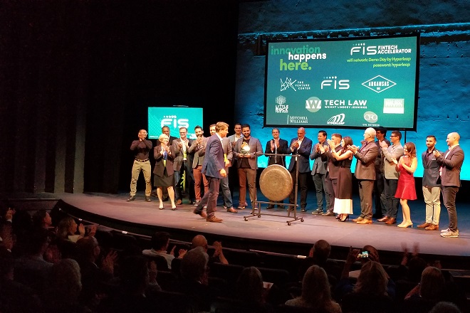 Spencer Jones, FIS enterprise product officer, flanked by the 2019 VC Fintech Accelerator participants, walks over to the Venture Center's ceremonial gong. He rang it Wednesday night to signal the end of the program, at the conclusion of its demo day event.