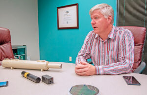 Walter Burgess, vice president of Power Technology Inc. of Alexander, describing the laser technology his company manufactures. A new enterprise, using laser lighting for movie theater projection, is the focus of a company being spun off, tentatively named CinemaLaser.