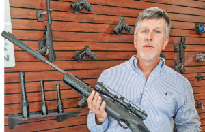 Adam Blalock, CEO of Umarex/Walther, holds one of his company’s high-powered air rifles at its corporate headquarters in Fort Smith.