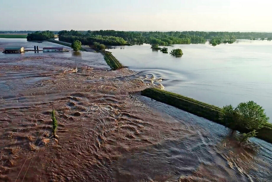 Water rushes through the levee along the Arkansas River in Dardanelle on May 31.