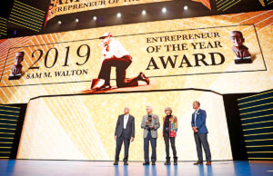 Rob Walton, Jim Walton, Alice Walton and Greg Penner presenting the Entrepreneur of the Year award at the 2019 Walmart shareholders meeting June 7 at Bud Walton Arena.
