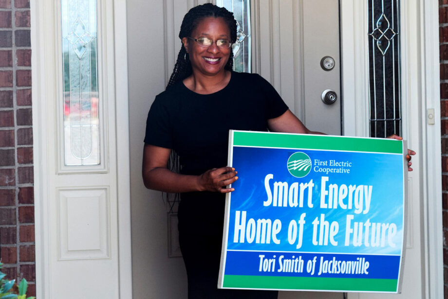 Tori Smith stands outside her Jacksonville home, which was recently updated by First Electric Cooperative with home automation technology designed to increase energy efficiency.