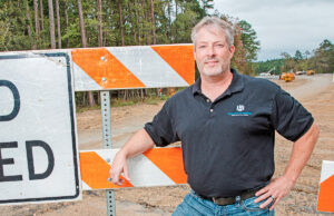 Eric Holloway, owner of Holloway Engineering, stands at the northern extension of White Oak Crossing, which will link with the new Maumelle interchange on Interstate 40.