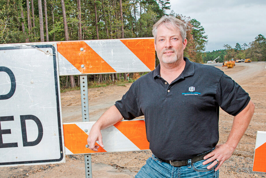 Eric Holloway, owner of Holloway Engineering, stands at the northern extension of White Oak Crossing, which will link with the new Maumelle interchange on Interstate 40.
