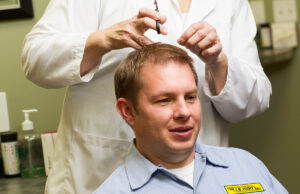 A driver for J.B. Hunt undergoes follicle sampling, which usually involves cutting or shaving an inch-and-a-half of hair.