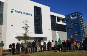 A crowd gathered Thursday to cut the ribbon for the grand opening of Safe Foods Corp.'s new headquarters in North Little Rock.