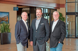 Van Tilbury, center, president and CEO of East Harding Construction, recently completed purchasing the company from Bob East, left, and Tom Harding.