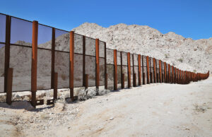 A steel fence sits on the border between Mexico and the United States in the Tinajas Altas Mountains.