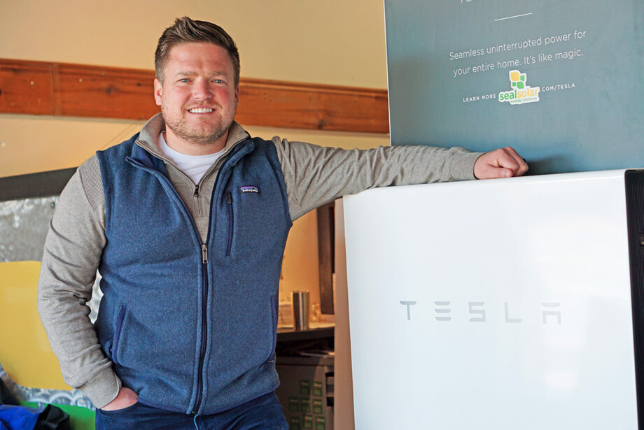 Josh Davenport, CEO of Seal Solar Solutions of North Little Rock, with a demonstration model of the Tesla Powerwall. Seal has installed several of the battery units with solar panel projects and is seeing increased interest in storage options.
