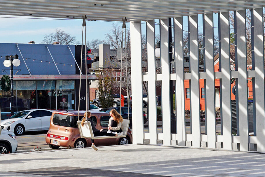 The “front porch” area of Argenta Plaza in North Little Rock drew a couple of visitors to the pergola’s swings last week.