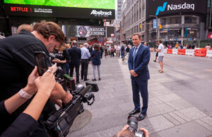 Peloton CEO John Foley poses for photographs outside the Nasdaq stock exchange in New York City during the initial public offering of Peloton Interactive on Sept. 26.