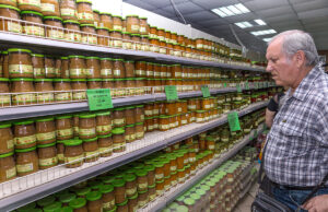 A customer surveys the wide selection of vegetable jars available inside a Ukranian supermarket.