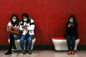 Passengers wearing face masks wait for the subway&nbsp;in Hong Kong last January.