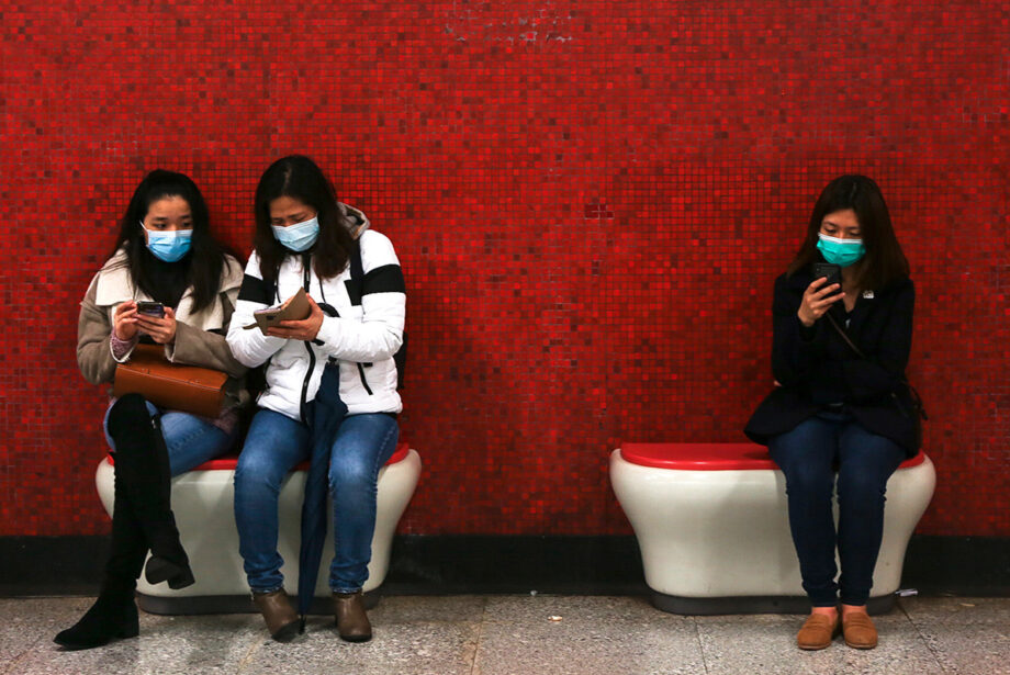 Passengers wearing face masks wait for the subway&nbsp;in Hong Kong last January.
