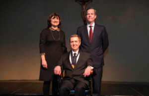 Dr. Scott Dickson (seated) with Stephanie Gardner, senior vice chancellor, and UAMS Chancellor Cam Patterson.