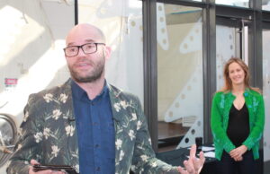 The Momentary Chairperson Olivia Walton looks on as Director Lieven Bertels makes remarks at the museum Friday.