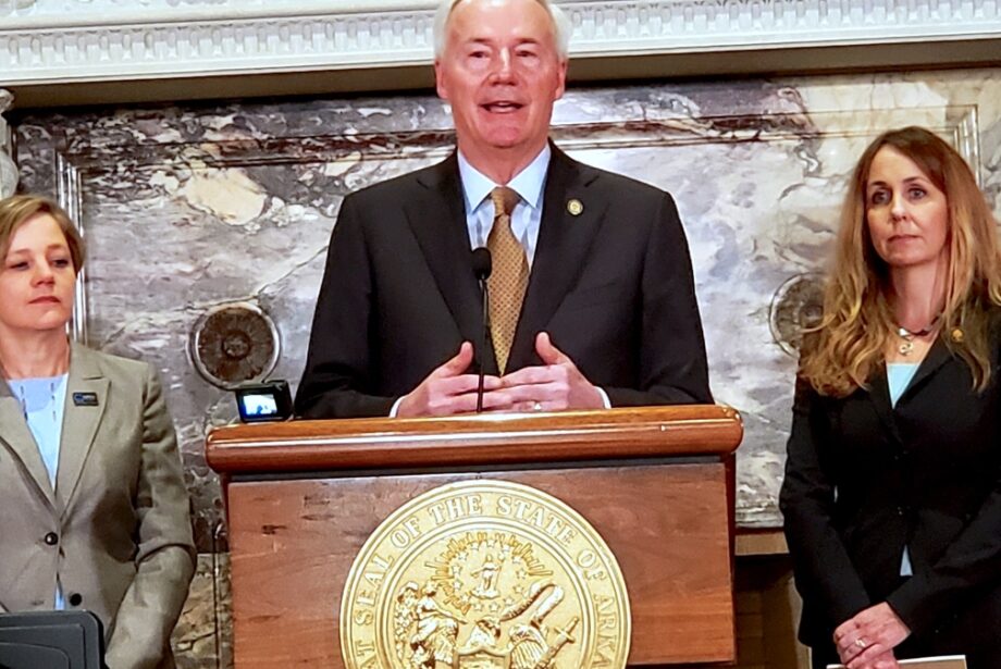 Gov. Asa Hutchinson, flanked by Marcy Doderer, CEO of Arkansas Children's (left), and state Sen. Missy Irvin, R-Mountain View.