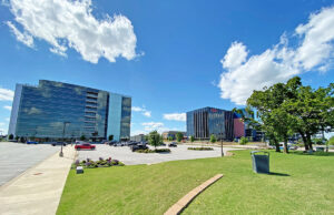 Parking lots remained empty last week at Pinnacle Hills in Rogers, home to the Hunt Tower, left, and Northgate Plaza.