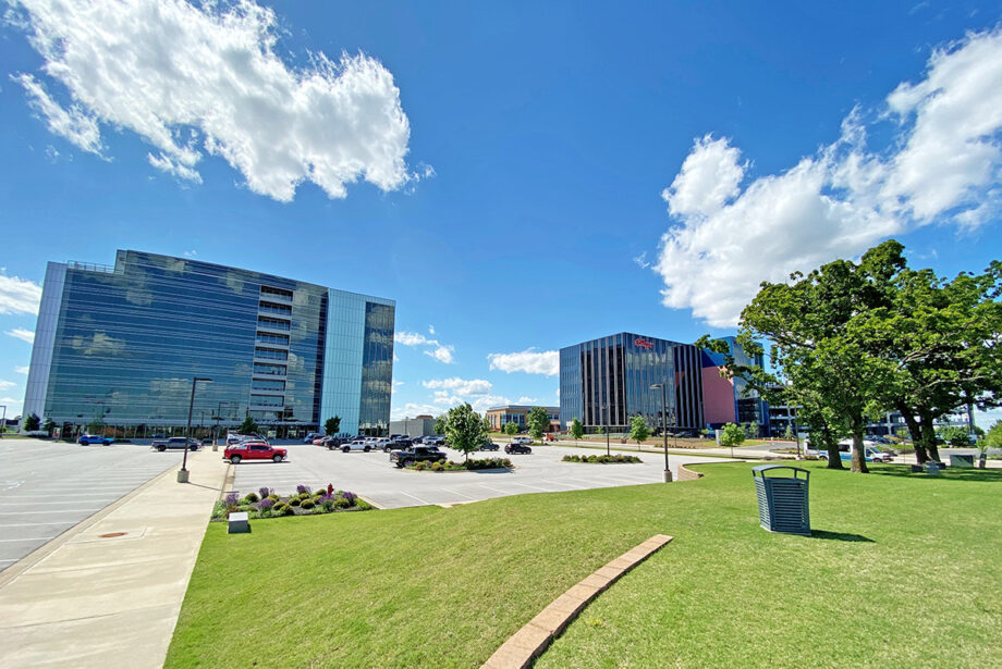 Parking lots remained empty last week at Pinnacle Hills in Rogers, home to the Hunt Tower, left, and Northgate Plaza.