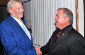 Retired Rich Mountain Electric Cooperative President and CEO&nbsp;Leon Philpot, left, shakes hands with&nbsp;his successor, Brad Castor.