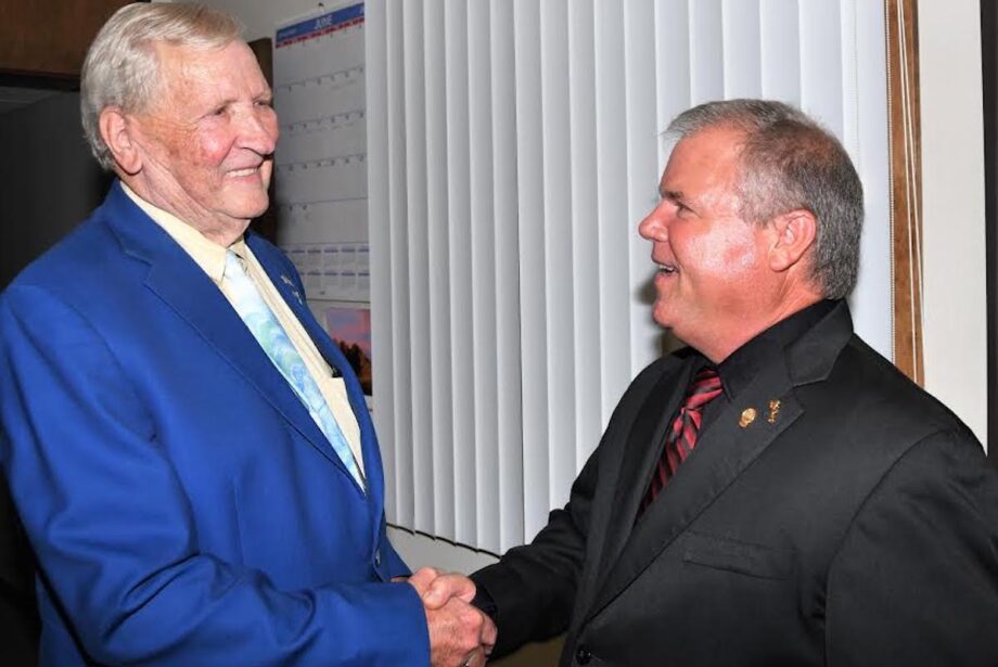 Retired Rich Mountain Electric Cooperative President and CEO&nbsp;Leon Philpot, left, shakes hands with&nbsp;his successor, Brad Castor.