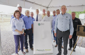 Leon Philpot, whose name adorns the new solar facility, is in the foreground at right, surrounded by others who&nbsp;unveiled the facility Thursday near Rich Mountain Electric Cooperative's headquarters in Mena.