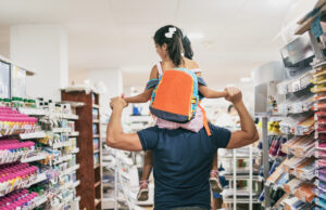 A father and daughter go back-to-school shopping.