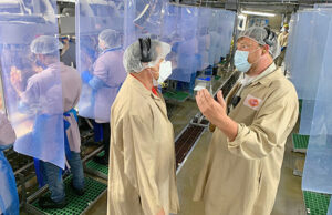 League of United Latin American Citizens president Domingo Garcia (left) discusses Tyson Foods safety improvement with plant manager Hunter Wray during a tour of the Springdale Berry Street facility in June.