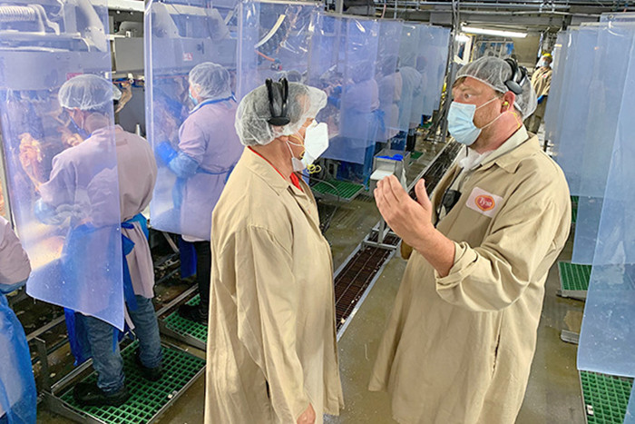 League of United Latin American Citizens president Domingo Garcia (left) discusses Tyson Foods safety improvement with plant manager Hunter Wray during a tour of the Springdale Berry Street facility in June.