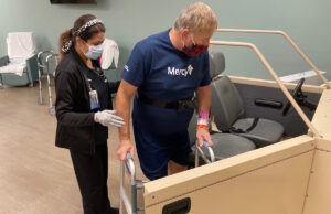 Jamie Moznabi, physical therapist assistant, helps patient Jerry Eagle during a therapy class after his knee replacement surgery.