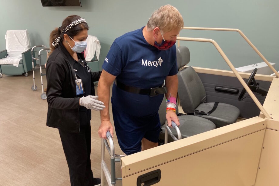 Jamie Moznabi, physical therapist assistant, helps patient Jerry Eagle during a therapy class after his knee replacement surgery.