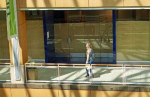 A lone shopper crosses a section of closed shops at Park Plaza in Little Rock.