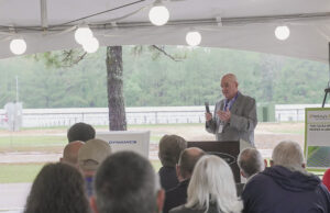 Ouachita Electric General Manager Mark Cayce speaks at the commissioning of&nbsp;General Dynamics Ordnance & Tactical Systems'&nbsp;new solar generation plant in East Camden.