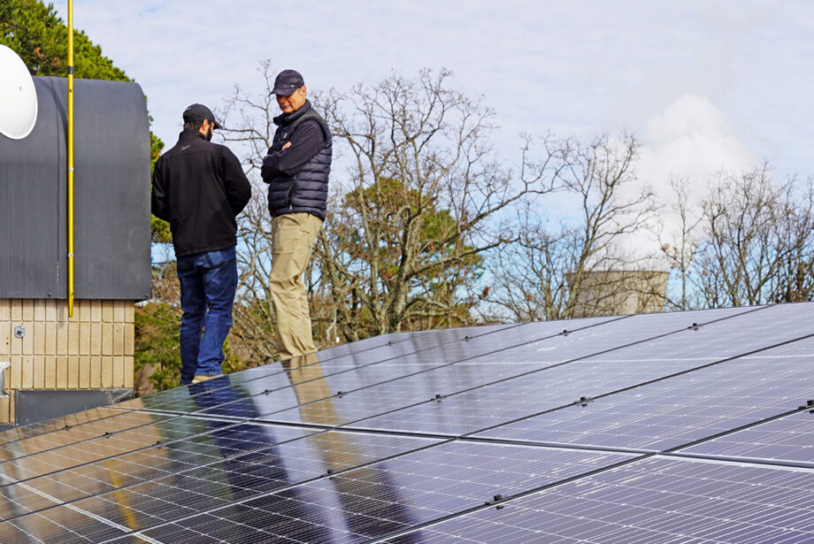 John Ekdahl of AEV Solar of Little Rock with a homeowner and client for a residential array in London (Pope County). Entergy&rsquo;s Arkansas Nuclear One is visible in the background.