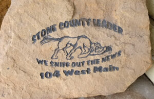 An engraved stone in a doorway on Main Street in Mountain View advertises the Stone County Leader.
