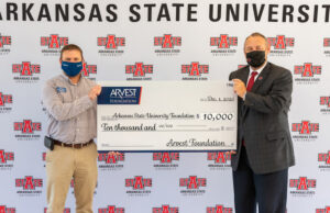 From left: Kevin Hufstedler, community bank president of Arvest Bank in Northeast Arkansas, presents a $10,000 check from the bank's foundation to A-State Chancellor&nbsp;Kelly Damphousse.
