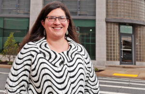 Rachel Patton of Preserve Arkansas wants higher historic tax credits for eligible projects.  Here, she’s outside one such project, Polk Stanley Wilcox’s building on Spring Street.