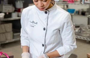 Carmen Portillo, owner of Cocoa Bella Chocolates, packages chocolate truffles at Arkitchen in Little Rock.