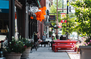 Visitors to the River Market District dine outside in front of the Library Kitchen & Lounge on President Clinton Avenue last summer.