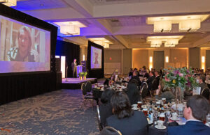 Johnelle Hunt of Lowell, honored with the Legacy of Leadership Award, addressed by video the limited number of in-person attendees split between two banquet rooms at the Arkansas Business of the Year awards in Little Rock.