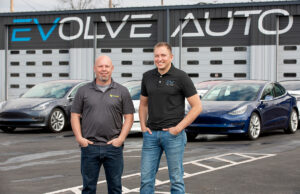 Greg Bradley, left, residential sales manager at Seal Solar, and Evolve Auto partner Collin Riggin are gearing up to offer Arkansans electric cars, solar panels and EV charging stations for their homes or businesses, perhaps packaged into a single financing deal. Seal took an “aggressive stake” in Evolve, the state’s only exclusively electric vehicle dealership.