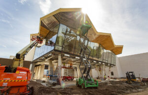The new Arkansas Museum of Fine Arts'&nbsp;signature roof &ndash; a flowing, folded plate concrete structure, blossoming out to the north and south &ndash; is now complete. Pictured here, along with the second floor's "cultural living room," the roofline spans the length of the new 133,000-SF building set to open in May 2022.