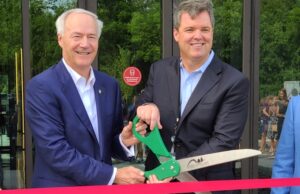Gov. Asa Hutchinson (left) and Transplace CEO Frank McGuigan mark the grand opening of the company's 150,000-SF center in Rogers.